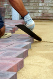 landscaping contractor laying patio pavers